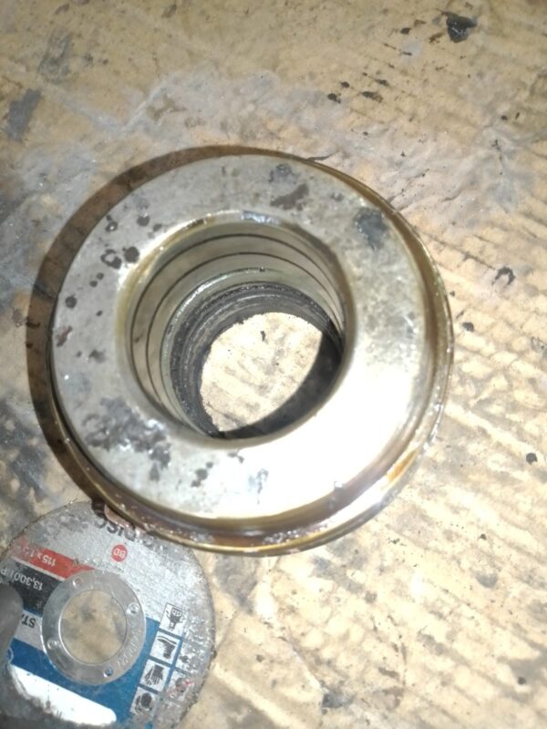 Hydraulic cylinder gland with seals removed for replacement