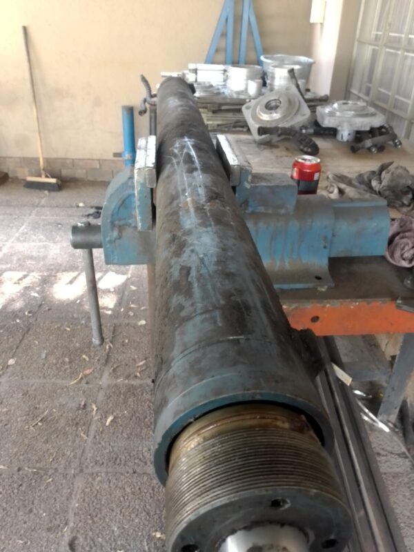 Hydraulic cylinder clamped in a vice for strip-down in the Hydraulic Squad workshop