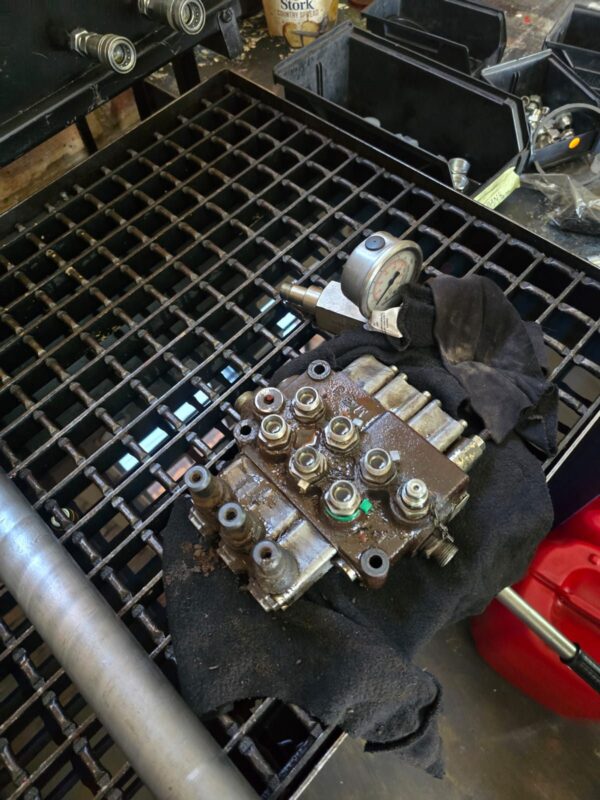 Hydraulic directional valve block stripped for repair on the workbench at Hydraulic Squad, Bronkhorstspruit