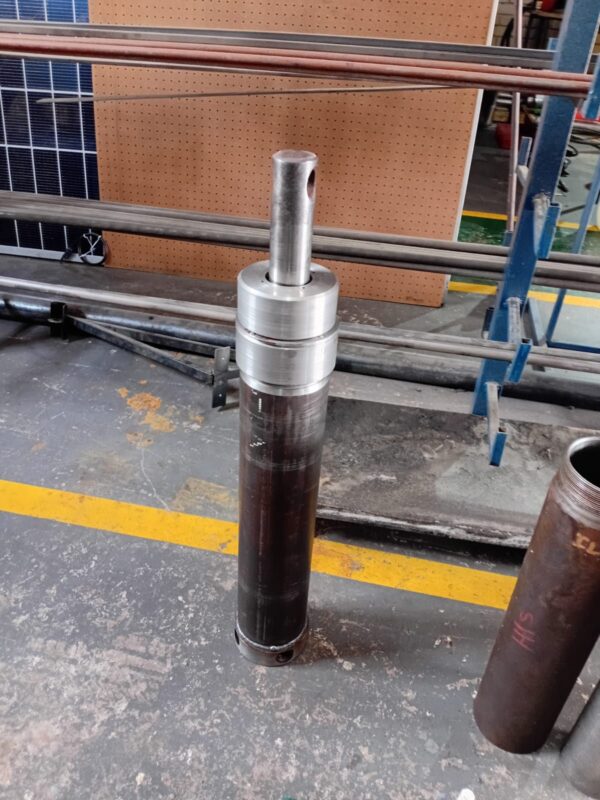 Large hydraulic cylinder being reassembled after a rebuild at Hydraulic Squad